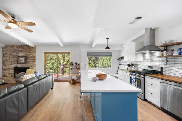 Fireplace, Interior, Kitchen, Living room, Pendant Lights, Stainless Steel Appliances, Stone Walls, Wood Texture Flooring