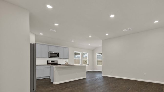 Empty room, Interior, Kitchen, Recessed Lighting, Stainless Steel Appliances, Wood Texture Flooring