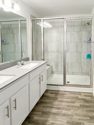 Bathroom, Dual Sink Vanities, Glass Shower, Interior, Marble Walls, Wood Texture Flooring