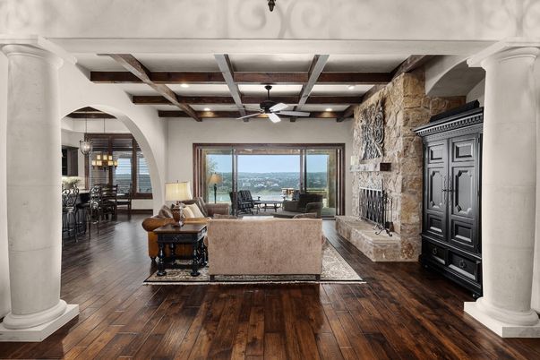 Chandelier, Dining room, Fireplace, Interior, Living room, Recessed Lighting, Stone Walls, Water, Wooden Beams, Wood Texture Flooring