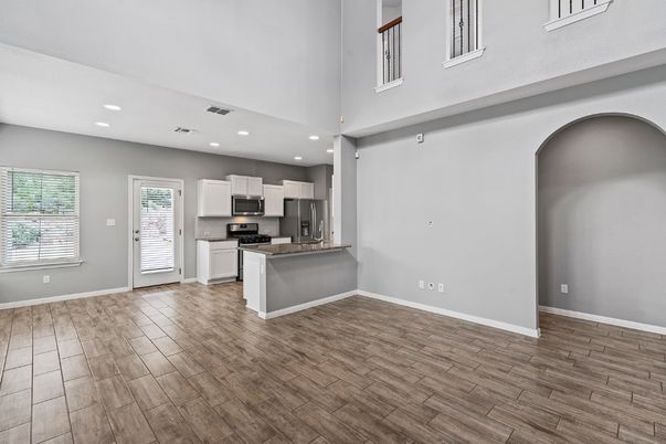Empty room, Interior, Kitchen, Recessed Lighting, Stainless Steel Appliances, Wood Texture Flooring