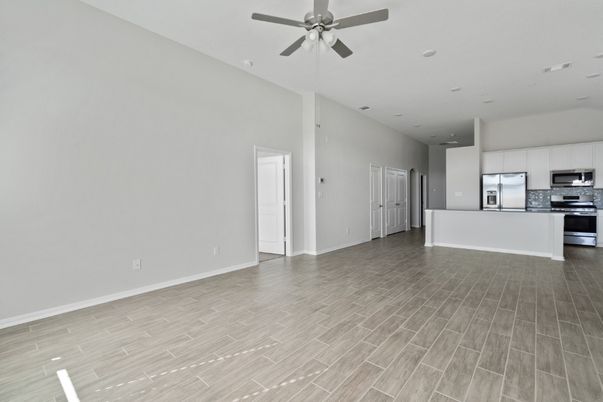 Empty room, Interior, Kitchen, Recessed Lighting, Stainless Steel Appliances, Wood Texture Flooring