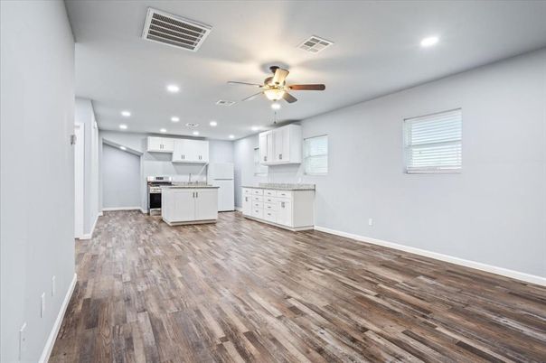 Empty room, Interior, Kitchen, Recessed Lighting, Stainless Steel Appliances, Wood Texture Flooring