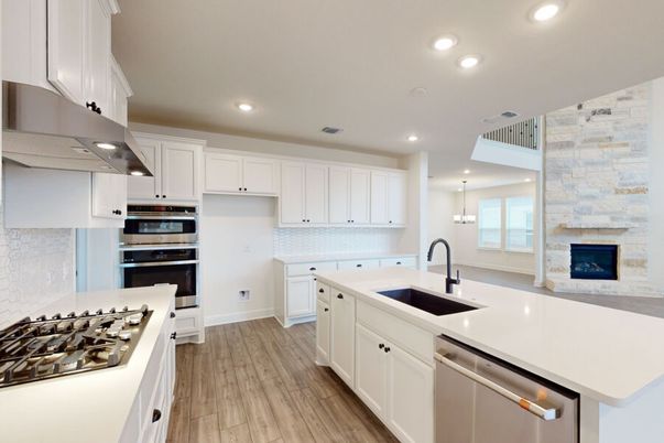 Fireplace, Interior, Kitchen, Pendant Lights, Recessed Lighting, Stainless Steel Appliances, Stone Walls, Wood Texture Flooring