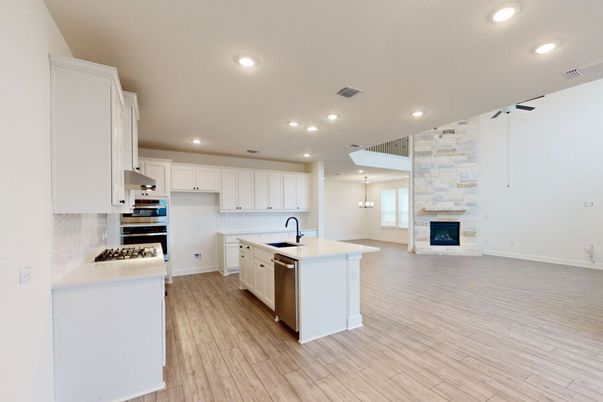 Fireplace, Interior, Kitchen, Pendant Lights, Recessed Lighting, Stainless Steel Appliances, Stone Walls, Wood Texture Flooring