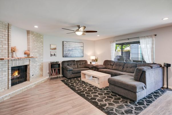 Fireplace, Interior, Living room, Recessed Lighting, Stone Walls, Wood Texture Flooring