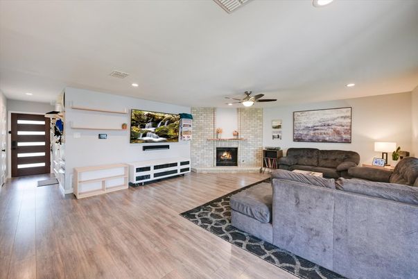 Fireplace, Interior, Living room, Recessed Lighting, Stone Walls, Wood Texture Flooring