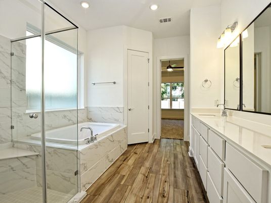 Bathroom, Dual Sink Vanities, Glass Shower, Interior, Marble Walls, Recessed Lighting, Wood Texture Flooring