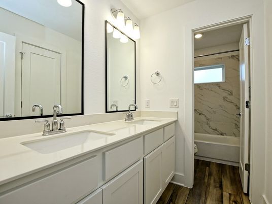 Bathroom, Dual Sink Vanities, Interior, Marble Walls, Recessed Lighting, Wood Texture Flooring