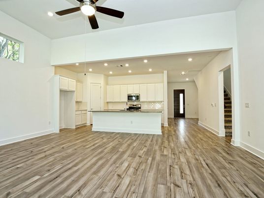 Empty room, Interior, Kitchen, Recessed Lighting, Stainless Steel Appliances, Wood Texture Flooring