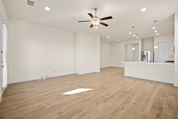 Empty room, Interior, Kitchen, Pendant Lights, Recessed Lighting, Stainless Steel Appliances, Wood Texture Flooring