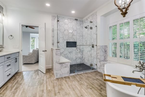 Bathroom, Free Standing Baths, Glass Shower, Interior, Marble Walls, Recessed Lighting, Wood Texture Flooring