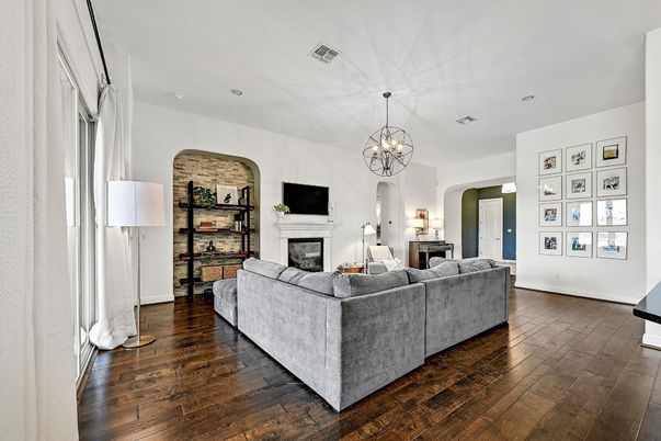 Chandelier, Fireplace, Interior, Living room, Recessed Lighting, Stone Walls, Wood Texture Flooring