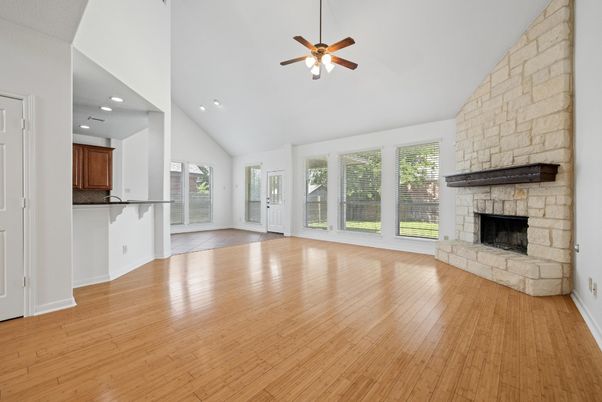 Empty room, Fireplace, Interior, Recessed Lighting, Stone Walls, Wood Texture Flooring