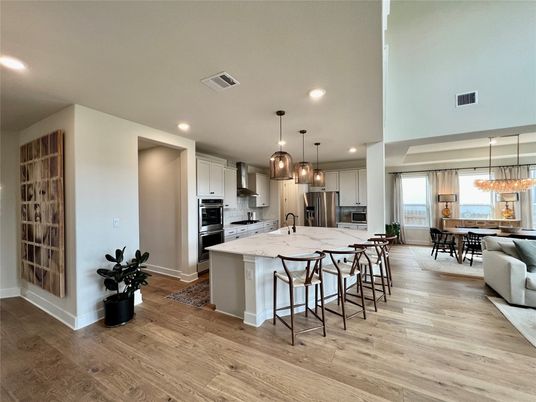 Chandelier, Dining room, Interior, Kitchen, Living room, Pendant Lights, Recessed Lighting, Stainless Steel Appliances, Wood Texture Flooring