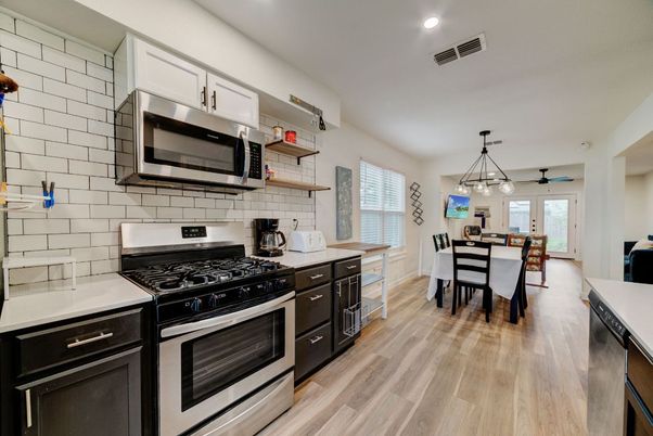 Dining room, Interior, Kitchen, Pendant Lights, Recessed Lighting, Stainless Steel Appliances, Wood Texture Flooring