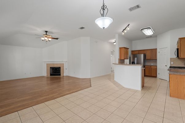 Empty room, Fireplace, Interior, Kitchen, Stainless Steel Appliances, Wood Texture Flooring