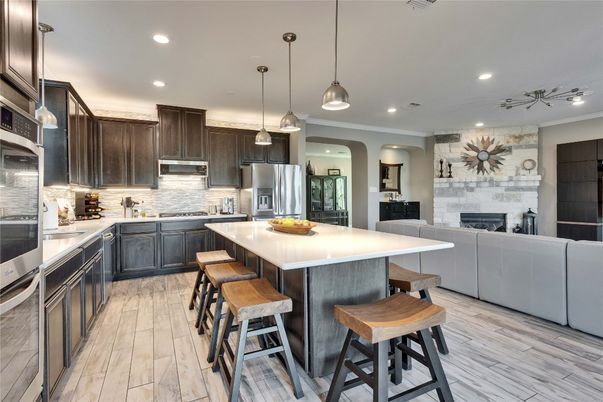 Fireplace, Interior, Kitchen, Pendant Lights, Recessed Lighting, Stainless Steel Appliances, Stone Walls, Wood Texture Flooring