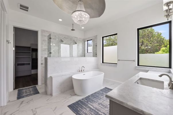 Bathroom, Chandelier, Dual Sink Vanities, Free Standing Baths, Glass Shower, Interior, Marble, Marble Walls, Recessed Lighting, Wood Texture Flooring