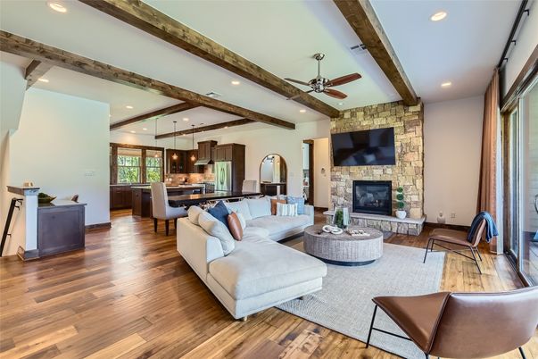 Fireplace, Interior, Kitchen, Living room, Pendant Lights, Recessed Lighting, Stainless Steel Appliances, Stone Walls, Wooden Beams, Wood Texture Flooring