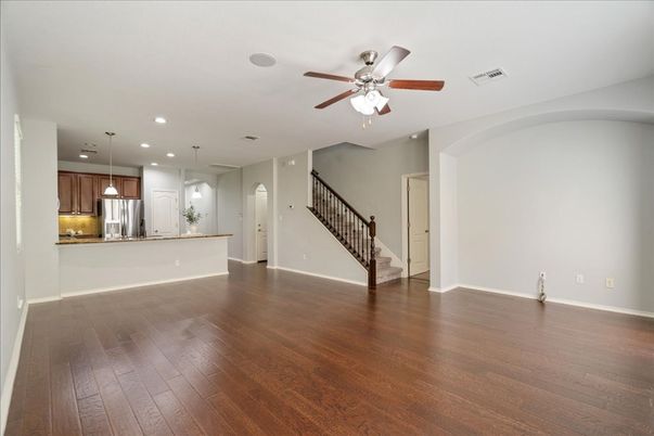 Empty room, Interior, Kitchen, Pendant Lights, Recessed Lighting, Stainless Steel Appliances, Wood Texture Flooring