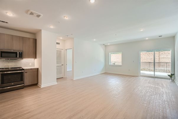 Empty room, Interior, Kitchen, Recessed Lighting, Stainless Steel Appliances, Wood Texture Flooring