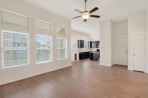 Empty room, Interior, Kitchen, Recessed Lighting, Stainless Steel Appliances, Wood Texture Flooring