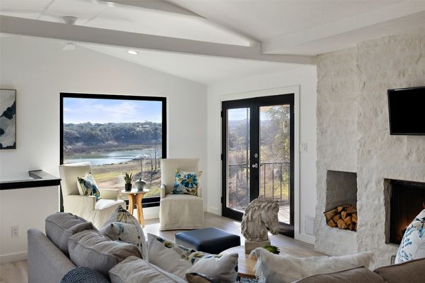 Fireplace, Interior, Living room, Recessed Lighting, Stone Walls, Water, Wood Texture Flooring