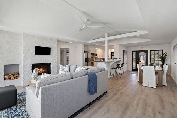 Dining room, Fireplace, Interior, Kitchen, Living room, Recessed Lighting, Stainless Steel Appliances, Stone Walls, Wood Texture Flooring