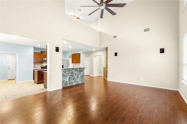 Empty room, Interior, Kitchen, Recessed Lighting, Stainless Steel Appliances, Wood Texture Flooring