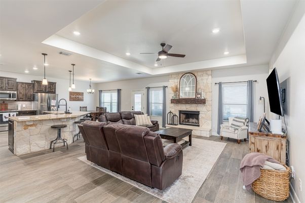 Fireplace, Interior, Kitchen, Living room, Pendant Lights, Recessed Lighting, Stainless Steel Appliances, Stone Walls, Wood Texture Flooring