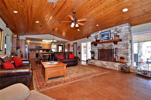 Fireplace, Interior, Kitchen, Living room, Pendant Lights, Recessed Lighting, Stainless Steel Appliances, Stone Walls, Wooden Ceilings