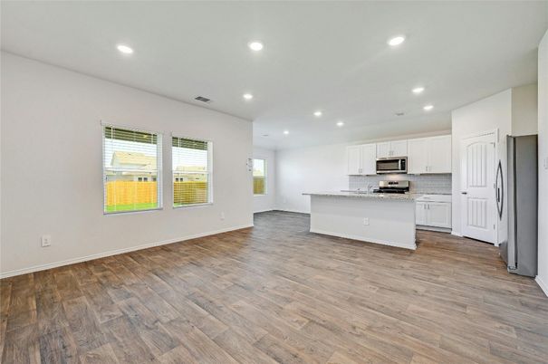 Empty room, Interior, Kitchen, Recessed Lighting, Stainless Steel Appliances, Wood Texture Flooring