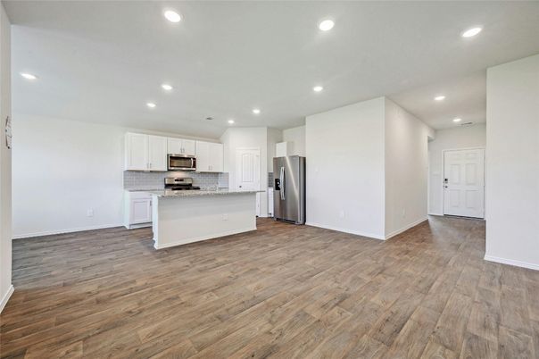 Empty room, Interior, Kitchen, Recessed Lighting, Stainless Steel Appliances, Wood Texture Flooring