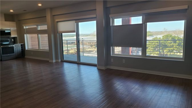 Empty room, Interior, Kitchen, Recessed Lighting, Stainless Steel Appliances, Wood Texture Flooring