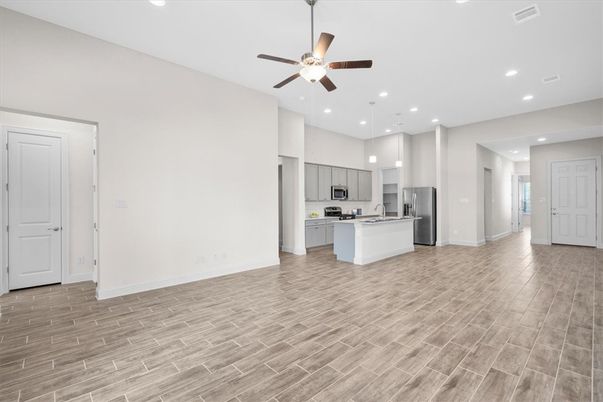 Empty room, Interior, Kitchen, Pendant Lights, Recessed Lighting, Stainless Steel Appliances, Wood Texture Flooring