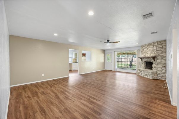 Empty room, Fireplace, Interior, Recessed Lighting, Stone Walls, Wood Texture Flooring