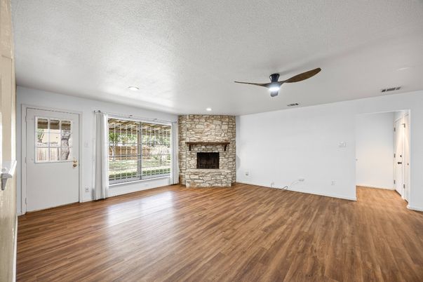 Empty room, Fireplace, Interior, Recessed Lighting, Stone Walls, Wood Texture Flooring