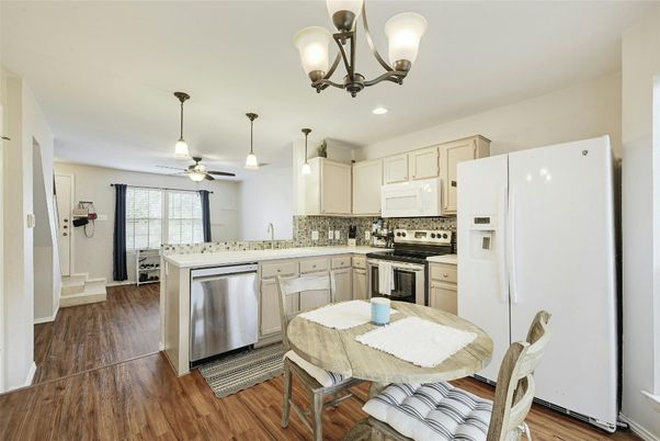 Chandelier, Dining room, Interior, Kitchen, Pendant Lights, Recessed Lighting, Stainless Steel Appliances, Wood Texture Flooring