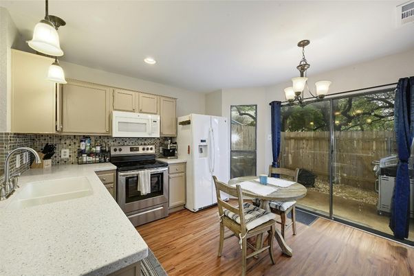 Chandelier, Dining room, Interior, Kitchen, Pendant Lights, Recessed Lighting, Stainless Steel Appliances, Wood Texture Flooring