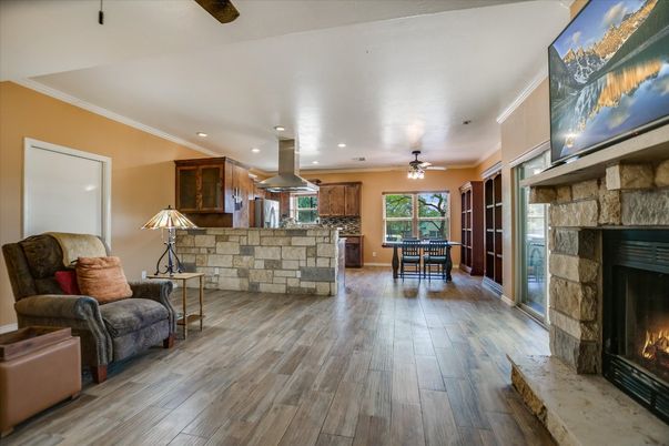 Dining room, Fireplace, Interior, Kitchen, Living room, Recessed Lighting, Stone Walls, Wood Texture Flooring