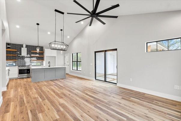 Empty room, Interior, Kitchen, Pendant Lights, Recessed Lighting, Stainless Steel Appliances, Stone Walls, Wood Texture Flooring