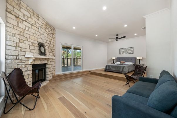 Bedroom, Fireplace, Interior, Living room, Recessed Lighting, Stone Walls, Wood Texture Flooring