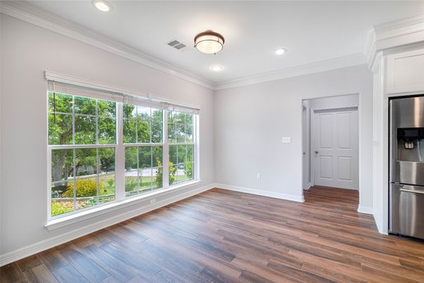 Empty room, Interior, Kitchen, Recessed Lighting, Stainless Steel Appliances, Wood Texture Flooring