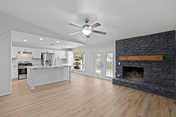 Fireplace, Interior, Kitchen, Recessed Lighting, Stainless Steel Appliances, Wood Texture Flooring