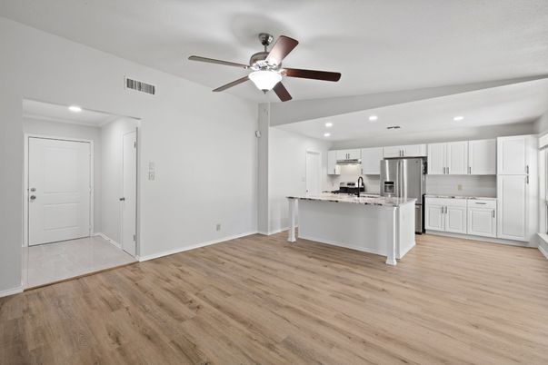 Empty room, Interior, Kitchen, Recessed Lighting, Stainless Steel Appliances, Wood Texture Flooring