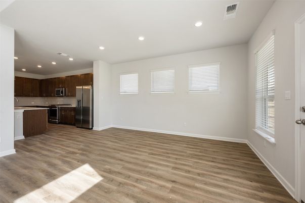 Empty room, Interior, Kitchen, Recessed Lighting, Stainless Steel Appliances, Wood Texture Flooring