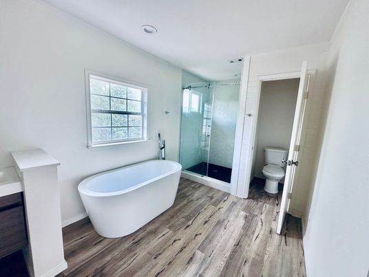 Bathroom, Free Standing Baths, Glass Shower, Interior, Recessed Lighting, Wood Texture Flooring
