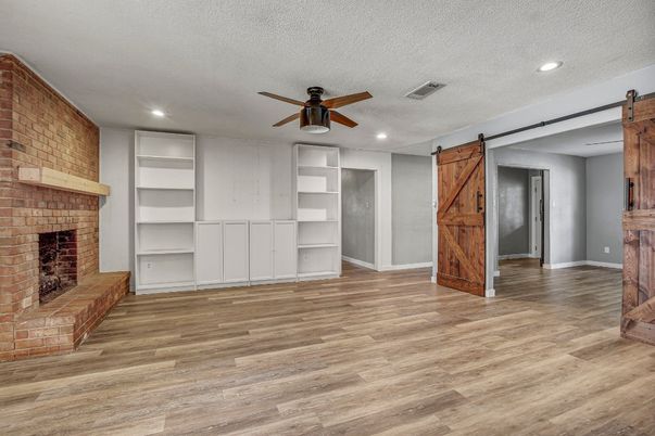 Empty room, Fireplace, Interior, Recessed Lighting, Stone Walls, Wood Texture Flooring