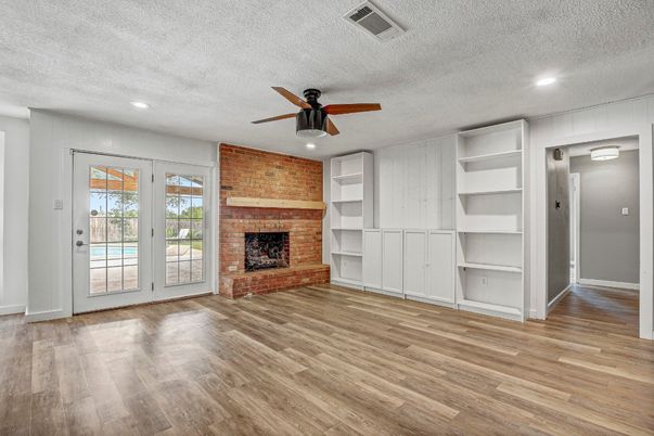 Empty room, Fireplace, Interior, Recessed Lighting, Stone Walls, Wood Texture Flooring